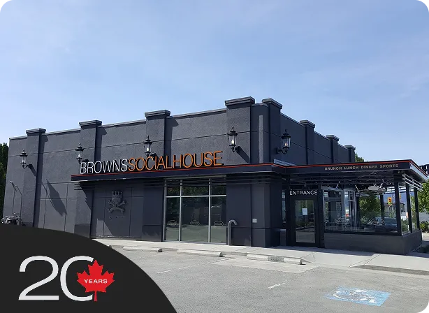 Commercial storefront with a custom steel entry canopy built by NxStar Systems