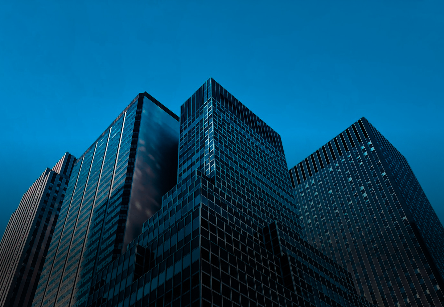 Glass and steel commercial towers viewed from street level